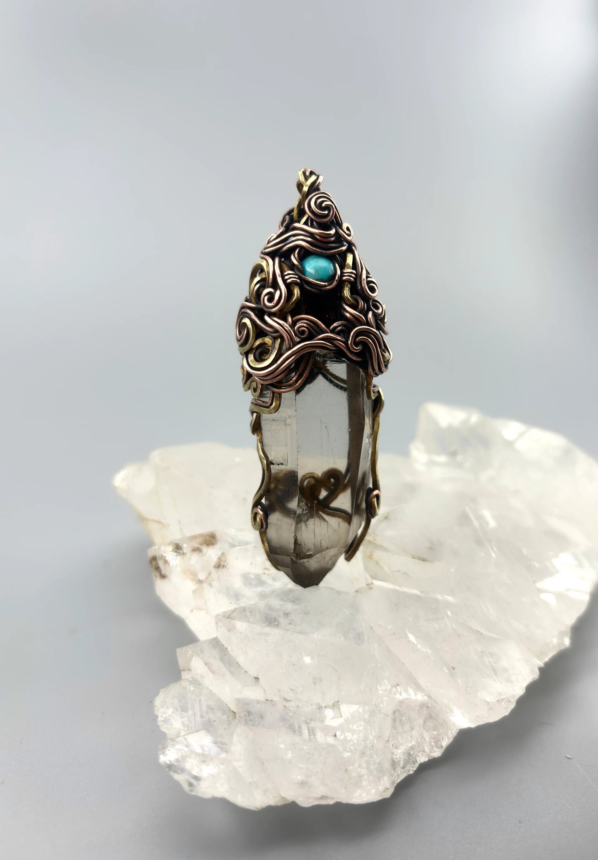 Crystal pendant with elaborate curved wirework