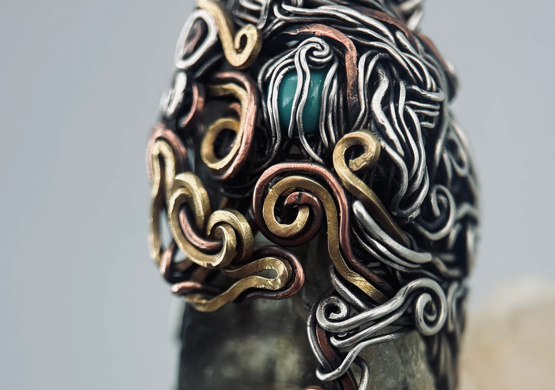 A wire wrapped crystal bracelet worn on a wrist